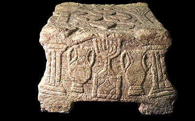 The Magdala Stone bears one of the earliest images of the seven-branched menorah from the Jewish Temple in Jerusalem. (Yael Yulowich, courtesy Israel Antiquities Authority)
