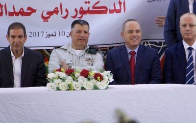The coordinator of government activities in the West Bank Yoav (Poli) Mordechai (second from left) and Minister of National Infrastructure, Energy and Water Resources Yuval Steinitz sit with Palestinian Authority Prime Minister Rami Hamdallah (far right) and Yiftah Ron-Tal, head of the Israel Electric Corporation (far left), at a ceremony to mark the first-ever signing of a commercial agreement between the two authorities to increase electricity in the West Bank area of Jenin, July 10, 2017. (Dov Lieber for the Times of Israel) The coordinator of government activities in the West Bank Yoav (Poli) Mordechai (second from left) and Minister of National Infrastructure, Energy and Water Resources Yuval Steinitz sit with Palestinian Authority Prime Minister Rami Hamdallah (far right) and Yiftah Ron-Tal, head of the Israel Electric Corporation (far left), at a ceremony to mark the first-ever signing of a commercial agreement between the two authorities to increase electricity in the West Bank area of Jenin, July 10, 2017. (Dov Lieber for the Times of Israel)