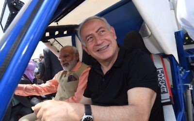 Benjamin Netanyahu, right, and Narendra Modi in a water purification buggy on Olga Beach on July 6, 2017. (Kobi Gideon/GPO)