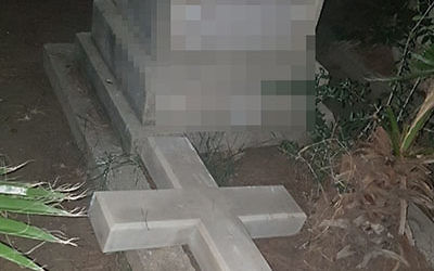 A cross toppled from a tombstone in the Templar Cemetery in Haifa (Israel Police)