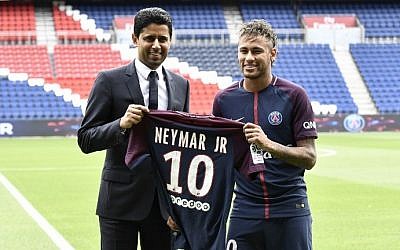 Brazilian superstar Neymar (R) poses with his jersey next to Paris Saint Germain's (PSG) Qatari president Nasser Al-Khelaifi during his official presentation at Paris' Parc des Princes stadium on August 4, 2017.
(AFP Photo/Philippe Lopez)