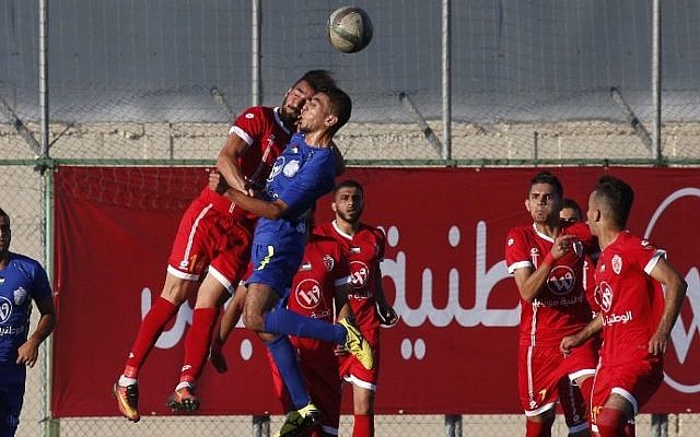 A player from Gaza's Shabab Rafah soccer team (blue) jumps to head the ball against a member of Hebron's Ahly Al-Ahli team during the second leg of the Palestinian Cup final at the stadium in the city of Dura, near the West Bank town of Hebron, on August 4, 2017. (AFP Photo/Hazem Bader) A player from Gaza's Shabab Rafah soccer team (blue) jumps to head the ball against a member of Hebron's Ahly Al-Ahli team during the second leg of the Palestinian Cup final at the stadium in the city of Dura, near the West Bank town of Hebron, on August 4, 2017. (AFP Photo/Hazem Bader)