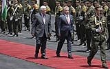 Jordan's King Abdullah II, center-right, and Palestinian Authority President Mahmoud Abbas, center-left, observe the honor guard during a visit by the Jordanian king to the West Bank city of Ramallah, August 7, 2017. (AFP/Ahmad GHARABLI)