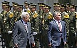 Jordan's King Abdullah II and Palestinian Authority President Mahmoud Abbas observe the honor guard during a visit in the West Bank city of Ramallah on August 7, 2017. (AFP PHOTO / ABBAS MOMANI)