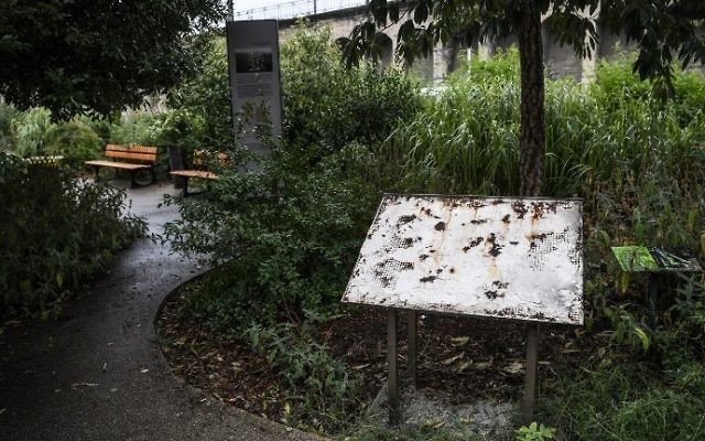 A photo taken on August 8, 2017, shows a plaque in Lyon in memory of Jewish children and adults deported after the roundup of Izieu in April 1944, after it was desecrated on the night of August 7. (AFP Photo/Philippe Desmazes)