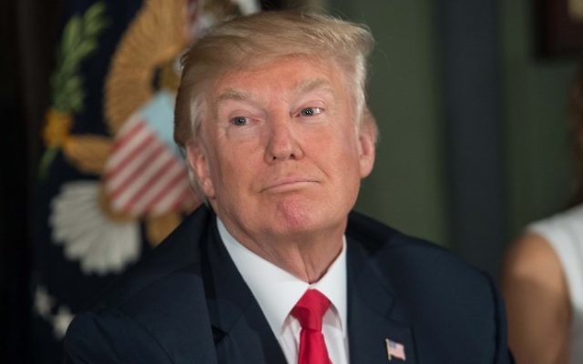 US President Donald Trump looks on before a meeting with administration officials on the opioid addiction crisis at the Trump National Golf Club in Bedminster, New Jersey, on August 8, 2017. (NICHOLAS KAMM / AFP_