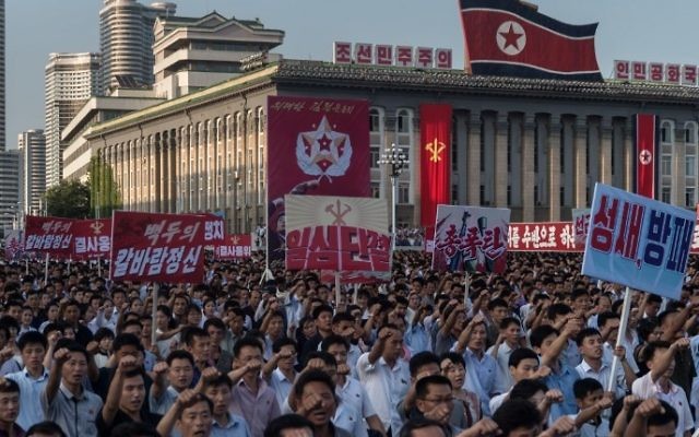 People wave banners and shout slogans as they attend a rally in support of North Korea's stance against the US, on Kim Il-Sung square in Pyongyang on August 9, 2017. (AFP PHOTO / KIM Won-Jin) People wave banners and shout slogans as they attend a rally in support of North Korea's stance against the US, on Kim Il-Sung square in Pyongyang on August 9, 2017. (AFP PHOTO / KIM Won-Jin)