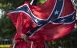 This file photo taken on July 8, 2017 shows a member of the Ku Klux Klan holding a Confederate flag over his face during a rally, calling for the protection of Southern Confederate monuments, in Charlottesville, Virginia. (AFP PHOTO / ANDREW CABALLERO-REYNOLDS)