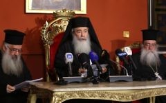 Greek Orthodox Patriarch of Jerusalem Theophilos III (C) speaks during a press conference in the Jordanian capital Amman on August 12, 2017. (AFP Photo/Khalil Mazraawi)