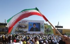 Supporters of the Lebanese Shiite movement Hezbollah watch a video screening of a speech by the group's head, Hassan Nasrallah, to mark the 11th anniversary of the end of the 2006 war with Israel, in the village of Khiam in southern Lebanon, August 13, 2017. (AFP/Mahmoud ZAYYAT)
