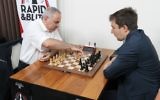 Grandmaster chess player Garry Kasparov, left, makes the first move as he plays grandmaster Sergey Karjakin of Russia in the opening round of the Grand Chess Tour at the Chess Club and Scholastic Center in St. Louis, August 14, 2017.  (AFP/BILL GREENBLATT)