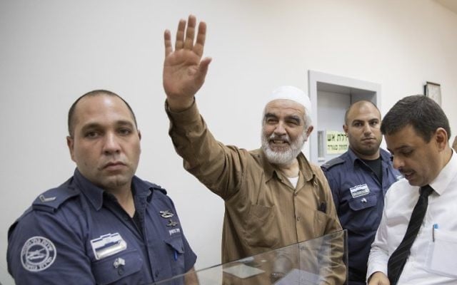 Sheikh Raed Salah, center, smiles as he arrives at the Israeli Rishon Lezion Magistrate's Court on August 15, 2017. (AFP/JACK GUEZ) Sheikh Raed Salah, center, smiles as he arrives at the Israeli Rishon Lezion Magistrate's Court on August 15, 2017. (AFP/JACK GUEZ)