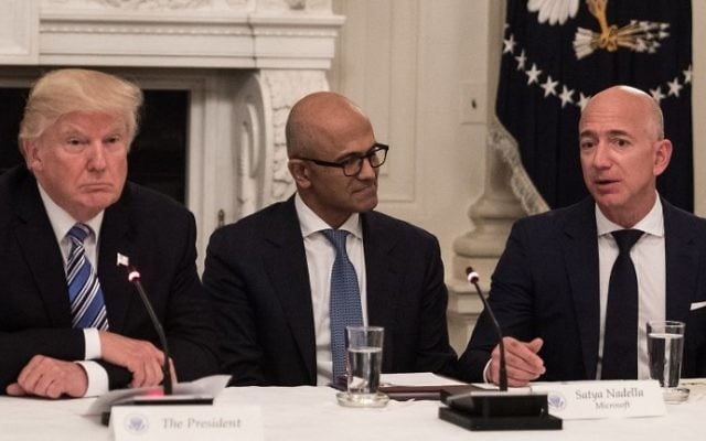 This file photo taken on June 19, 2017, shows US President Donald Trump (L) and Microsoft CEO Satya Nadella (C) as they listen to Amazon CEO Jeff Bezos (R) during an American Technology Council roundtable at the White House. (AFP Photo/Nicholas Kamm) This file photo taken on June 19, 2017, shows US President Donald Trump (L) and Microsoft CEO Satya Nadella (C) as they listen to Amazon CEO Jeff Bezos (R) during an American Technology Council roundtable at the White House. (AFP Photo/Nicholas Kamm)