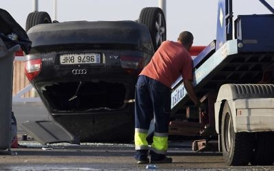A worker starts to tow away a car involved in a terrorist attack in Cambrils, about 75 miles south of Barcelona, on August 18, 2017. (AFP/Lluis Gene)