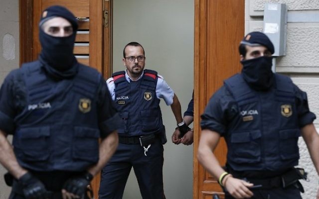 File: Catalan police officers detain a suspect in Ripoll during a search linked to the deadly terror attacks in Barcelona and the seaside resort of Cambrils, on August 18, 2017. (AFP Photo/Pau Barrena)