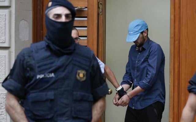 Catalan autonomous police officers, known as Mosso d'Esquadra, detain a cuffed suspect in Ripoll during a search linked to the deadly terror attacks in Barcelona and the seaside resort of Cambrils on August 18, 2017, a day after a van plowed into the crowd, killing 14 people and injuring over 100 on the Rambla in Barcelona.
(AFP PHOTO / PAU BARRENA) Catalan autonomous police officers, known as Mosso d'Esquadra, detain a cuffed suspect in Ripoll during a search linked to the deadly terror attacks in Barcelona and the seaside resort of Cambrils on August 18, 2017, a day after a van plowed into the crowd, killing 14 people and injuring over 100 on the Rambla in Barcelona.
(AFP PHOTO / PAU BARRENA)