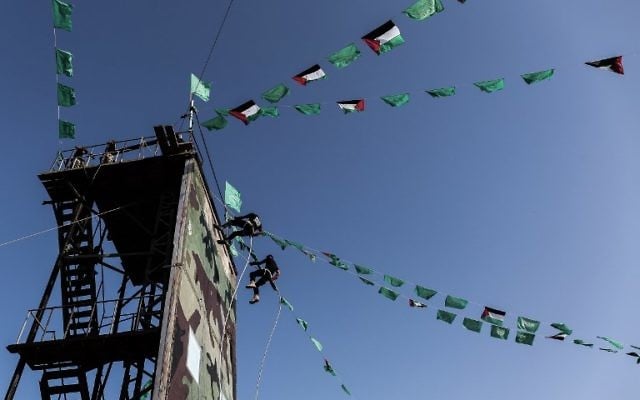 Young Palestinians abseil during a military graduation ceremony at a Hamas summer camp in Khan Yunis, in the southern Gaza Strip, on August 18, 2017. (AFP PHOTO / SAID KHATIB)