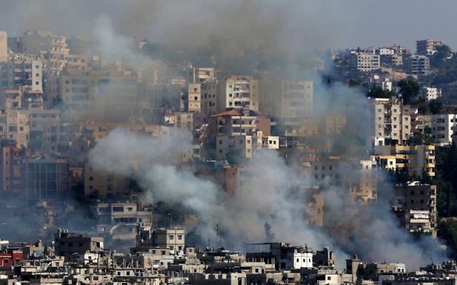 Smoke rises from buildings in Ain el-Helweh, Lebanon's largest Palestinian refugee camp, near the southern coastal city of Sidon, during clashes between Palestinian forces and Islamist fighters on August 19, 2017.(AFP PHOTO / Mahmoud ZAYYAT) Smoke rises from buildings in Ain el-Helweh, Lebanon's largest Palestinian refugee camp, near the southern coastal city of Sidon, during clashes between Palestinian forces and Islamist fighters on August 19, 2017.(AFP PHOTO / Mahmoud ZAYYAT)