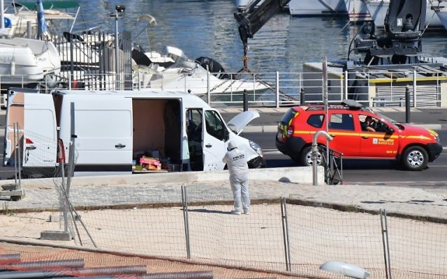 French forensic police officers search a vehicle following a car crash in the southern Mediterranean city of Marseille on August 21, 2017. (AFP/BERTRAND LANGLOIS) French forensic police officers search a vehicle following a car crash in the southern Mediterranean city of Marseille on August 21, 2017. (AFP/BERTRAND LANGLOIS)