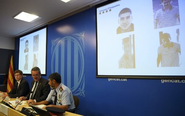 Catalan Interior Minister Joaquim Forn, center speaks past police chief Josep Lluis Trapero, right, and Justice Minister Carles Mundo during a press conference in Barcelona on August 21, 2017. (AFP / LLUIS GENE) Catalan Interior Minister Joaquim Forn, center speaks past police chief Josep Lluis Trapero, right, and Justice Minister Carles Mundo during a press conference in Barcelona on August 21, 2017. (AFP / LLUIS GENE)