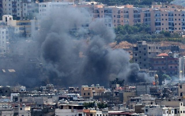 Smoke rises from buildings in Ain el-Helweh, Lebanon's largest Palestinian refugee camp, near the southern coastal city of Sidon, during ongoing clashes between Palestinian security forces and Islamist fighters on August 21, 2017. (AFP/Mahmoud ZAYYAT) Smoke rises from buildings in Ain el-Helweh, Lebanon's largest Palestinian refugee camp, near the southern coastal city of Sidon, during ongoing clashes between Palestinian security forces and Islamist fighters on August 21, 2017. (AFP/Mahmoud ZAYYAT)