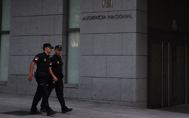 FILE - Spanish policemen walk in front of a Madrid court, on August 22, 2017, before the arrival of four men suspected of involvement in the terror cell that carried out twin attacks in Spain. (AFP Photo/Gabriel Bouys) FILE - Spanish policemen walk in front of a Madrid court, on August 22, 2017, before the arrival of four men suspected of involvement in the terror cell that carried out twin attacks in Spain. (AFP Photo/Gabriel Bouys)