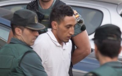 Driss Oukabir, suspected of involvement in the terror cell that carried out twin attacks in Spain, is escorted by Spanish Civil Guards from a detention center in Tres Cantos, near Madrid, August 22, 2017. (AFP PHOTO / STRINGER)