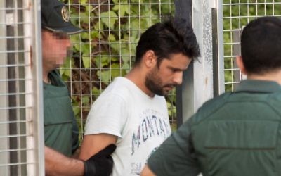 Mohamed Aallaa, suspected of involvement in the terror cell that carried out twin attacks in Spain, is escorded by Spanish Civil Guards from a detention center in Tres Cantos, near Madrid, on August 22, 2017 before being tranferred to the National Court.(AFP PHOTO / STRINGER)