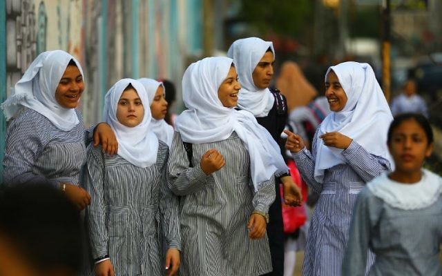 Illustrative: Palestinian schoolgirls chat as they head to school on the first day of a new academic year, at a United Nations-run school at the Al-Shatee refugee camp in Gaza City on August 23, 2017 (AFP/ MOHAMMED ABED) Illustrative: Palestinian schoolgirls chat as they head to school on the first day of a new academic year, at a United Nations-run school at the Al-Shatee refugee camp in Gaza City on August 23, 2017 (AFP/ MOHAMMED ABED)