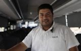 East Jerusalem Palestinian bus driver Ramadan Jamjoum poses on August 24, 2017 after he returned $10,000 to a Jewish man who left it in his vehicle. The passenger had forgotten the cash in Bnei Brak, a city near Tel Aviv dominated by ultra-Orthodox Jews. (AFP PHOTO / AHMAD GHARABLI)