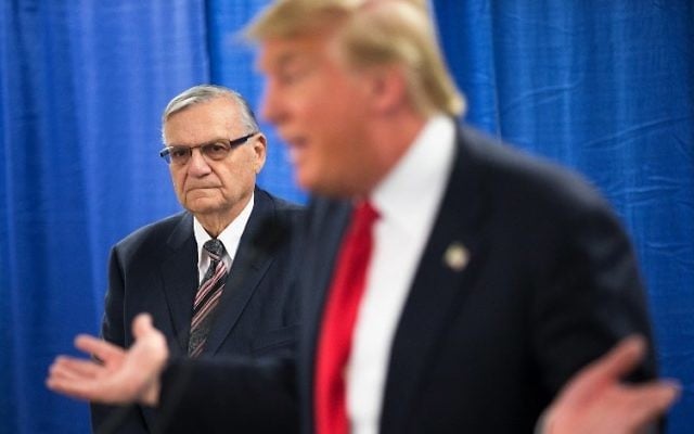 This file photo taken on January 25, 2016, shows Sheriff Joe Arpaio listening as Republican presidential candidate Donald Trump speaks to the press prior to a rally in Marshalltown, Iowa. (AFP/Getty Images North America/Scott Olson) This file photo taken on January 25, 2016, shows Sheriff Joe Arpaio listening as Republican presidential candidate Donald Trump speaks to the press prior to a rally in Marshalltown, Iowa. (AFP/Getty Images North America/Scott Olson)