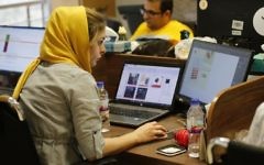 This file photo taken on July 9, 2017, shows Bamilo employees working at the e-commerce site's offices in the Iranian capital Tehran. (AFP Photo/Atta Kenare)