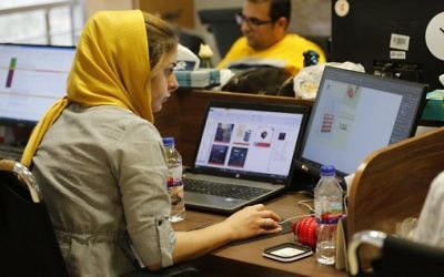 This file photo taken on July 9, 2017, shows Bamilo employees working at the e-commerce site's offices in the Iranian capital Tehran. (AFP Photo/Atta Kenare)
