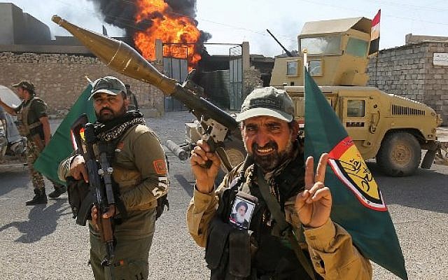 Fighters of Hashed Al-Shaabi (Popular Mobilization units) gather at the Tal Afar airport, west of Mosul, as Iraqi forces backed by local militia and a US-led coalition advanced in driving the Islamic State group from the city, on August 27, 2017. (AFP Photo/Ahmad al-Rubaye) Fighters of Hashed Al-Shaabi (Popular Mobilization units) gather at the Tal Afar airport, west of Mosul, as Iraqi forces backed by local militia and a US-led coalition advanced in driving the Islamic State group from the city, on August 27, 2017. (AFP Photo/Ahmad al-Rubaye)