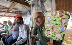 Relatives of Lebanese soldiers taken hostage by jihadists in 2014 sit inside a tent as they gather in downtown Beirut on August 27, 2017 awaiting news of their loved ones. (AFP PHOTO / ANWAR AMRO)