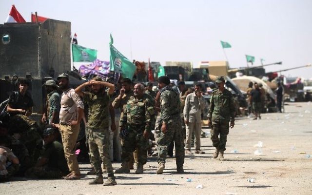 Fighters of Hashed Al-Shaabi (Popular Mobilization units) gather at the Tal Afar airport, west of Mosul, as Iraqi forces backed by local militia and a US-led coalition advanced in driving the Islamic State group from the city, on August 27, 2017. (AFP Photo/Ahmad al-Rubaye) Fighters of Hashed Al-Shaabi (Popular Mobilization units) gather at the Tal Afar airport, west of Mosul, as Iraqi forces backed by local militia and a US-led coalition advanced in driving the Islamic State group from the city, on August 27, 2017. (AFP Photo/Ahmad al-Rubaye)