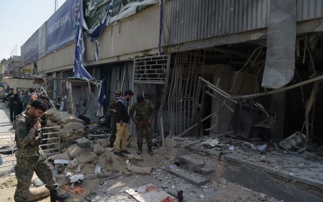 Afghan security personnel inspect the site of a suicide attack outside a bank near the US embassy in Kabul on August 29, 2017. (AFP PHOTO / SHAH MARAI) Afghan security personnel inspect the site of a suicide attack outside a bank near the US embassy in Kabul on August 29, 2017. (AFP PHOTO / SHAH MARAI)