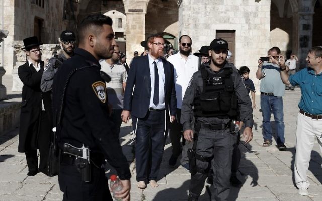 MK Yehuda Glick (C-L) walks barefoot, escorted by Israeli police and supporters, inside the flash-point Temple Mount complex in Jerusalem's Old City on August 29, 2017. (Ahmad Gharabli/AFP) MK Yehuda Glick (C-L) walks barefoot, escorted by Israeli police and supporters, inside the flash-point Temple Mount complex in Jerusalem's Old City on August 29, 2017. (Ahmad Gharabli/AFP)