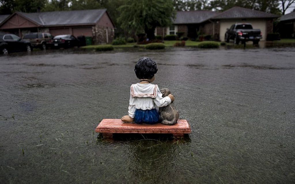 A lawn ornament is seen on a flooded street during the aftermath of Hurricane Harvey August 29, 2017 in Houston, Texas. (AFP/ Brendan Smialowski)