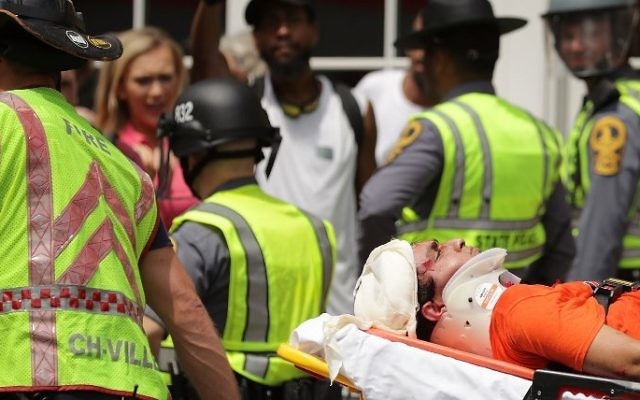 Rescue workers move victims on stretchers after car plowed through a crowd of counter-demonstrators marching through the downtown shopping district August 12, 2017 in Charlottesville, Virginia. (Chip Somodevilla/Getty Images/AFP) Rescue workers move victims on stretchers after car plowed through a crowd of counter-demonstrators marching through the downtown shopping district August 12, 2017 in Charlottesville, Virginia. (Chip Somodevilla/Getty Images/AFP)