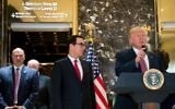 Trailed by (left to right) Director of the National Economic Council Gary Cohn and Treasury Secretary Steve Mnuchin, US President Donald Trump arrives to deliver remarks following a meeting on infrastructure at Trump Tower, August 15, 2017, in New York City. (Drew Angerer/Getty Images/AFP)