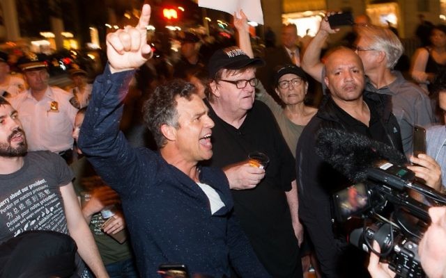 Mark Ruffalo, left, joins Michael Moore, center, as he leads his Broadway audience to Trump Tower to protest President Donald Trump on August 15, 2017 in New York City. (Noam Galai/Getty Images for DKC/O&M/AFP) Mark Ruffalo, left, joins Michael Moore, center, as he leads his Broadway audience to Trump Tower to protest President Donald Trump on August 15, 2017 in New York City. (Noam Galai/Getty Images for DKC/O&M/AFP)