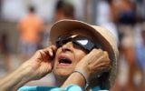 A spectator looks skyward during a partial eclipse of the sun on August 21, 2017 at the Cradle of Aviation Museum in Garden City, New York. (Bruce Bennett/Getty Images/AFP)