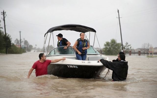 People are rescued from a flooded neighborhood after it was inundated with rain water, remnants of Hurricane Harvey, in Houston, Texas August 28, 2017. (Scott Olson/Getty Images/AFP) People are rescued from a flooded neighborhood after it was inundated with rain water, remnants of Hurricane Harvey, in Houston, Texas August 28, 2017. (Scott Olson/Getty Images/AFP)