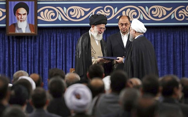 In this photo released by official website of the office of the Iranian supreme leader, Supreme leader Ayatollah Ali Khamenei, left, gives his official seal of approval to President Hassan Rouhani as deputy chief of supreme leader's office Vahid Haghanian looks on in an endorsement ceremony in Tehran, Iran, Thursday, Aug. 3, 2017. A portrait of the late revolutionary founder Ayatollah Khomeini hangs at left. (Office of the Iranian Supreme Leader via AP) In this photo released by official website of the office of the Iranian supreme leader, Supreme leader Ayatollah Ali Khamenei, left, gives his official seal of approval to President Hassan Rouhani as deputy chief of supreme leader's office Vahid Haghanian looks on in an endorsement ceremony in Tehran, Iran, Thursday, Aug. 3, 2017. A portrait of the late revolutionary founder Ayatollah Khomeini hangs at left. (Office of the Iranian Supreme Leader via AP)
