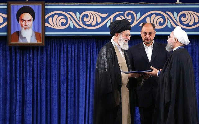 Supreme leader Ayatollah Ali Khamenei, left, gives his official seal of approval to President Hassan Rouhani as deputy chief of supreme leader's office Vahid Haghanian looks on in an endorsement ceremony in Tehran, Iran, Thursday, Aug. 3, 2017. A portrait of the late revolutionary founder Ayatollah Khomeini hangs at left. (Office of the Iranian Supreme Leader via AP) Supreme leader Ayatollah Ali Khamenei, left, gives his official seal of approval to President Hassan Rouhani as deputy chief of supreme leader's office Vahid Haghanian looks on in an endorsement ceremony in Tehran, Iran, Thursday, Aug. 3, 2017. A portrait of the late revolutionary founder Ayatollah Khomeini hangs at left. (Office of the Iranian Supreme Leader via AP)
