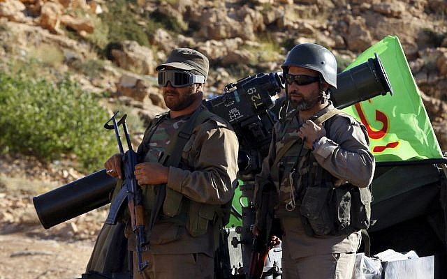 Hezbollah fighters stand on their army vehicle at the site where clashes erupted between Hezbollah and al-Qaeda-linked fighters in Wadi al-Kheil or al-Kheil Valley in the Lebanon-Syria border, July 29, 2017. (AP Photo/Bilal Hussein) Hezbollah fighters stand on their army vehicle at the site where clashes erupted between Hezbollah and al-Qaeda-linked fighters in Wadi al-Kheil or al-Kheil Valley in the Lebanon-Syria border, July 29, 2017. (AP Photo/Bilal Hussein)