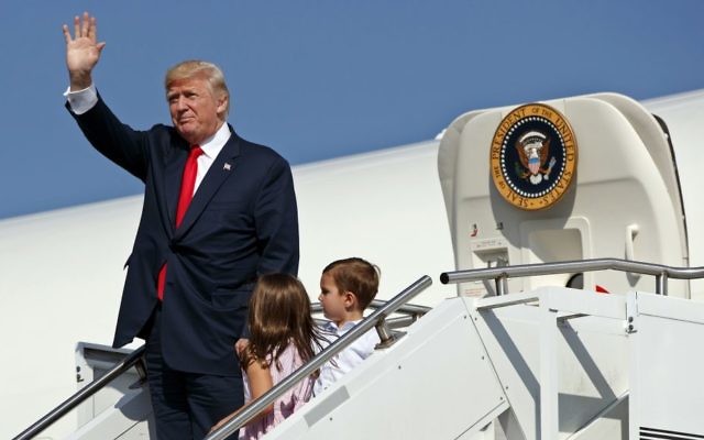 In this Aug. 4, 2017, photo, US President Donald Trump waves as he walks down the steps of Air Force One with his grandchildren, Arabella Kushner, center, and Joseph Kushner, right, after arriving at Morristown Municipal Airport to begin his summer vacation at his Bedminster golf club in Morristown, N.J. (AP Photo/Evan Vucci) In this Aug. 4, 2017, photo, US President Donald Trump waves as he walks down the steps of Air Force One with his grandchildren, Arabella Kushner, center, and Joseph Kushner, right, after arriving at Morristown Municipal Airport to begin his summer vacation at his Bedminster golf club in Morristown, N.J. (AP Photo/Evan Vucci)