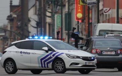 A police vehicle blocks a road in the Molenbeek suburb of Brussels, Tuesday, Aug. 8, 2017. (AP Photo/Olivier Matthys)