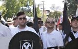In this Saturday, August 12, 2017 photo, James Alex Fields Jr., second from left, holds a black shield in Charlottesville, Virginia, where a white supremacist rally took place. Fields was later charged with second-degree murder and other counts after authorities say he plowed a car into a crowd of people protesting the white nationalist rally. (Alan Goffinski via AP)